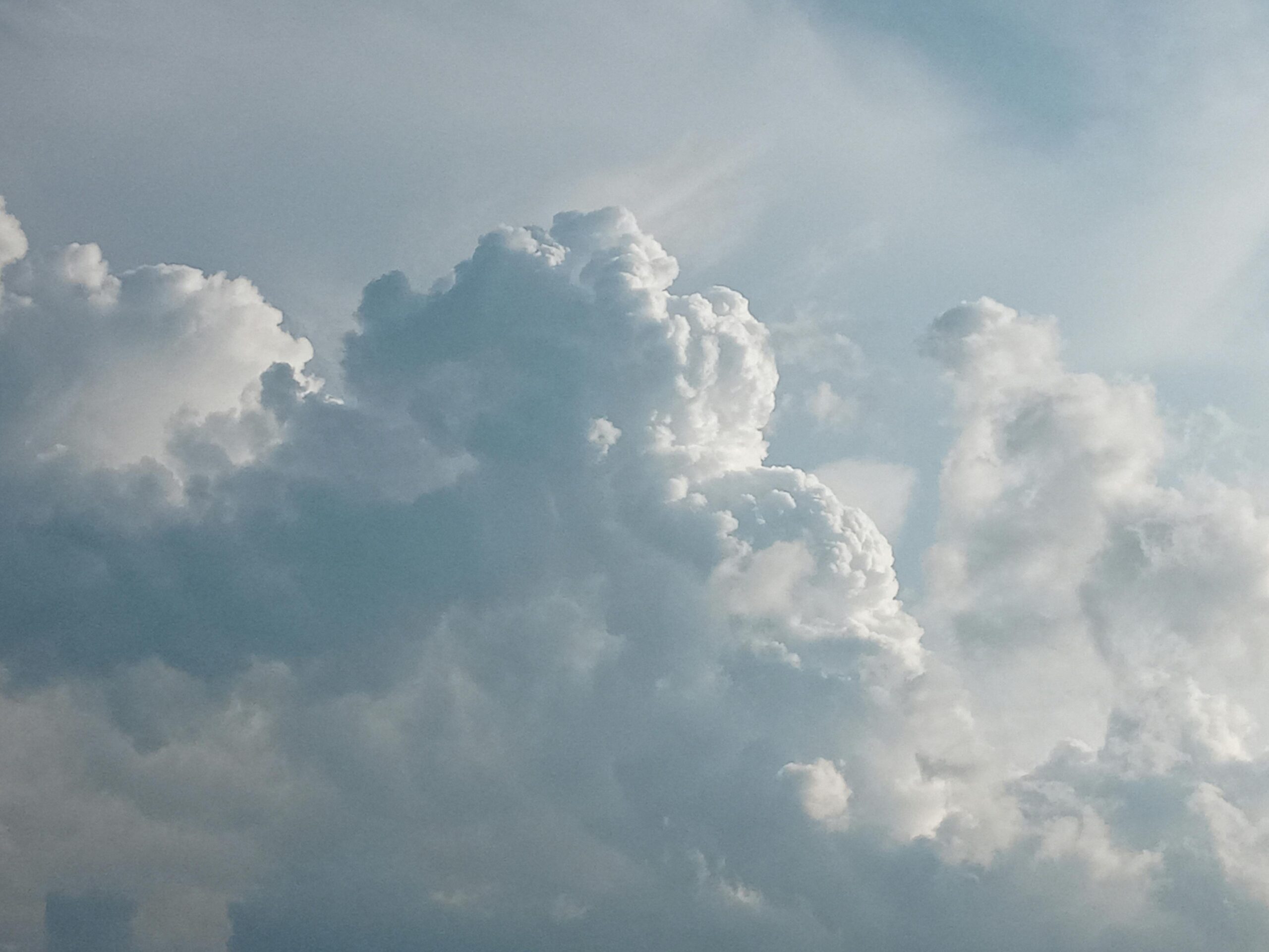 A captivating view of cumulus clouds against a bright blue sky, ideal for weather and nature themes.